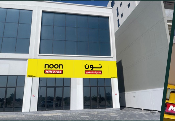 Shopfront with bilingual yellow signage and entrance glazing in the original profile