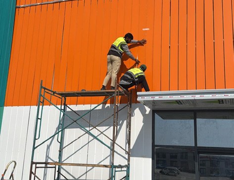 Shopfront cladding installation work shown in the company profile