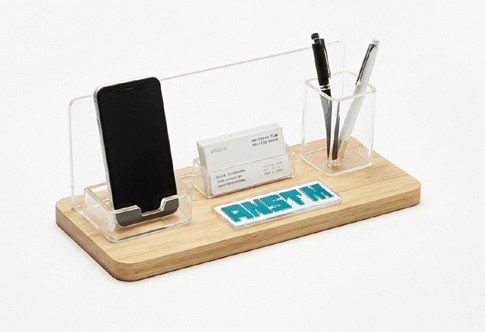 Branded wooden desktop organiser shown in the company profile