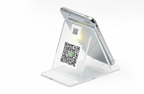 Desktop stand displaying a QR business card from the company profile